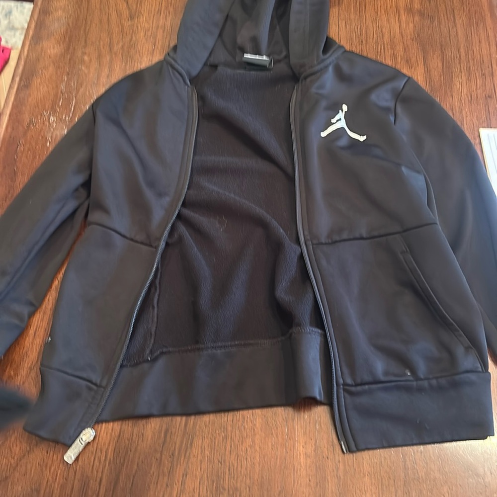 This is a black Jordan zip up hoodie